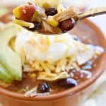 Slow Cooker Chicken Tortilla Soup ~ this effortless, hearty, taco-seasoned soup is brimming with chicken, beans, and corn and topped with crushed tortilla chips, sour cream, and grated cheddar...sure to become a fall and winter favorite! | FiveHeartHome.com