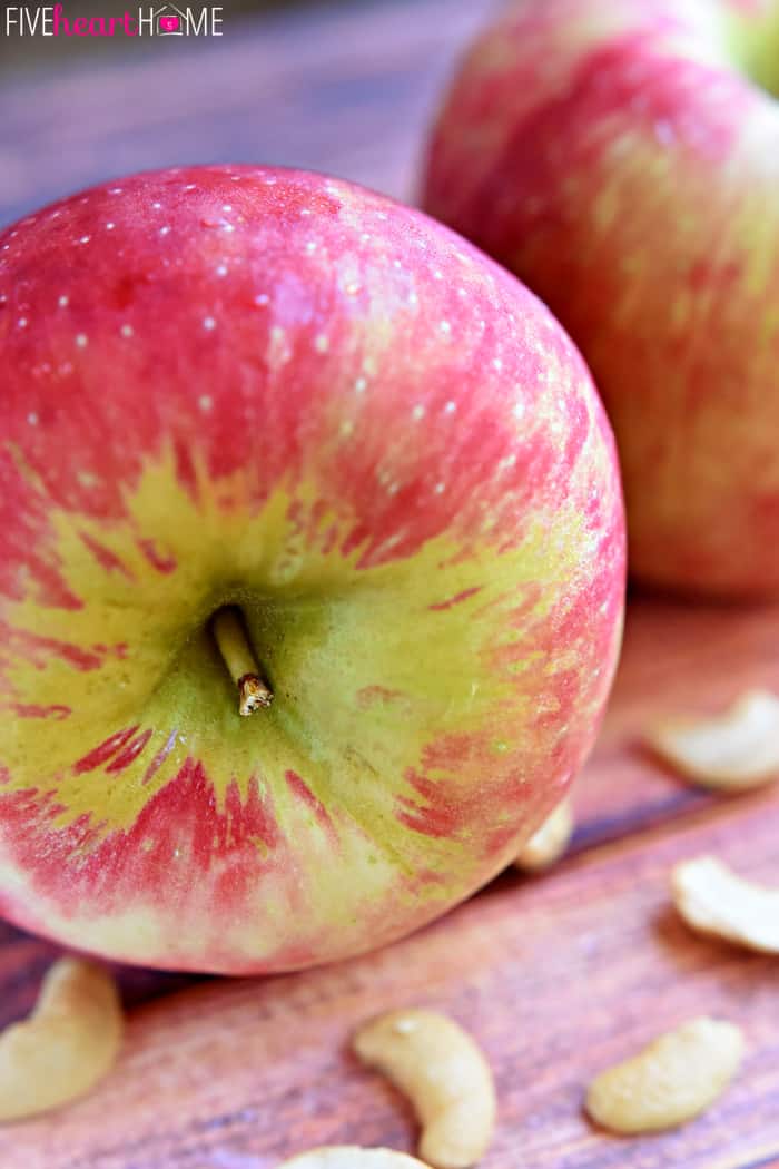 Close-up of honeycrisps and cashews on table. 