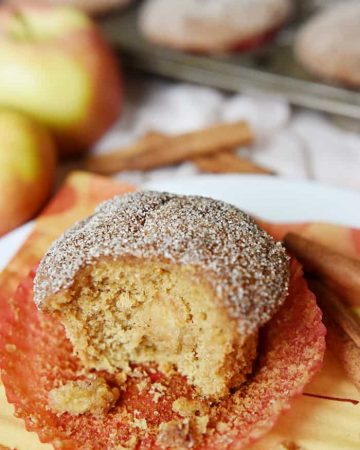 Whole Wheat Apple Cinnamon Muffins are soft and moist, bursting with tender apples, made wholesome by whole wheat flour and coconut oil, and topped with a cinnamon sugar coating | FiveHeartHome.com