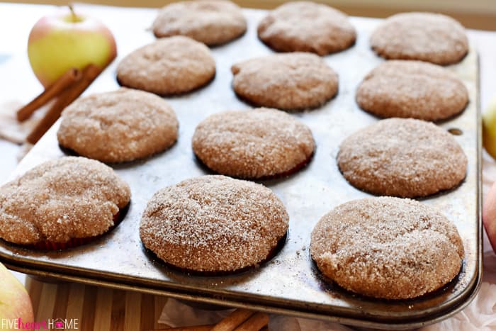 Whole Wheat Apple Cinnamon Muffins are soft and moist, bursting with tender apples, made wholesome by whole wheat flour and coconut oil, and topped with a cinnamon sugar coating | FiveHeartHome.com Apple Cinnamon Muffins in a muffin pan