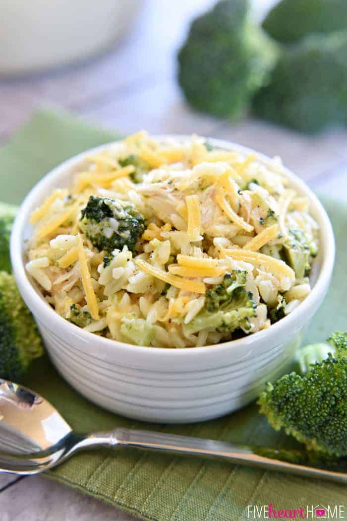 Broccoli Cheese Orzo with Chicken in White Bowl, Silver Spoon and Topped with Shredded Cheese 