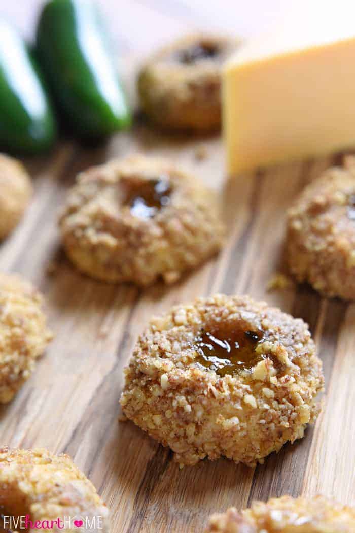 Savory Thumbprint Cookies on table with block of cheddar and jalapeños.