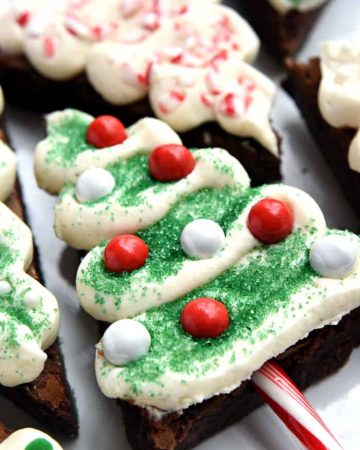 Christmas Tree Brownie Pops ~ fudgy brownies, tangy cream cheese frosting, candy cane "trunks," and lots of festive sprinkles make these Christmas cookies perfect for decorating with kids, filling a holiday cookie platter, giving as food gifts, or leaving for Santa! | FiveHeartHome.com