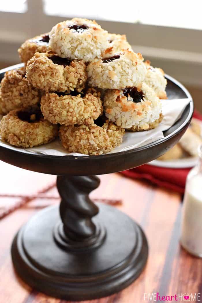 Jam Thumbprint Cookies stacked on wooden pedestal.