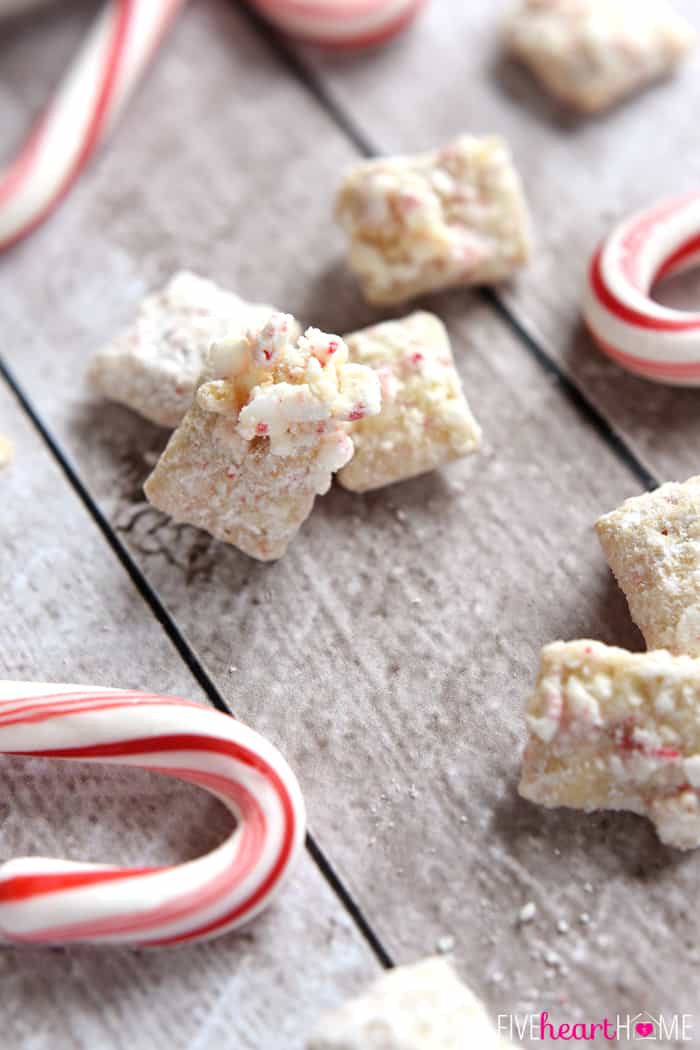 Christmas Puppy Chow, or Muddy Buddies, sprinkled on table.