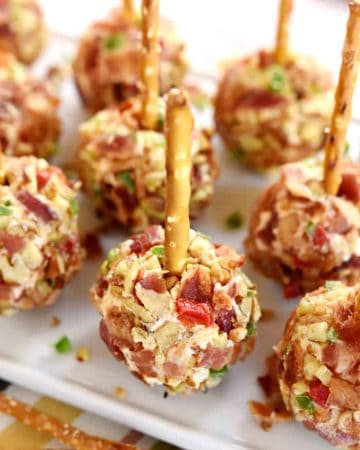 Tray of Pimento Cheese Balls with pretzel skewers.