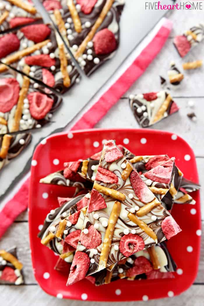 Aerial view of Strawberry Chocolate Pretzel Bark on a square red and white polka dot plate 