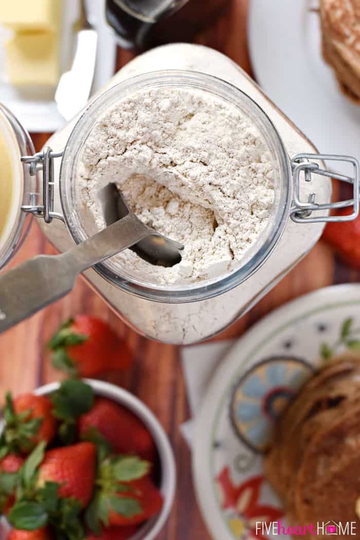 Aerial view of glass jar of Whole Wheat Pancake Mix with scoop.