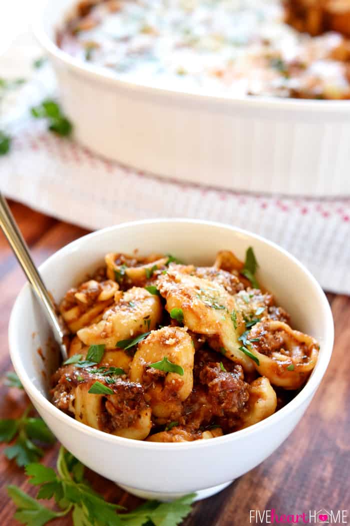 Baked Tortellini in baking dish and serving bowl with spoon.