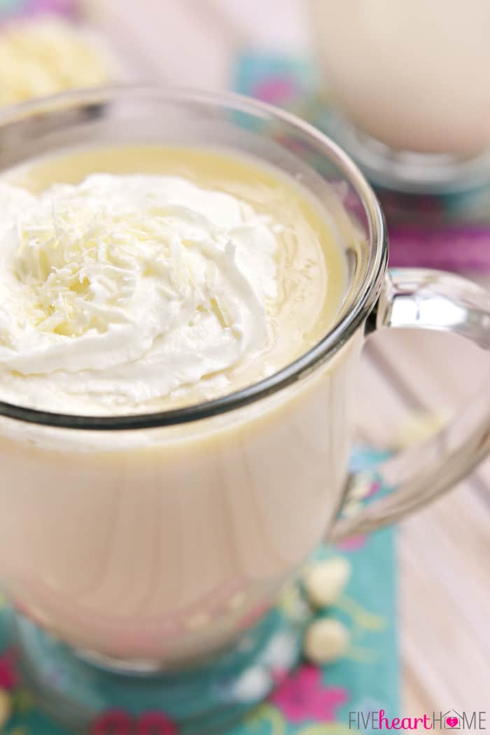 Cookie Butter White Hot Chocolate in Glass Mug with Whipped Cream and White Shaved Chocolate 