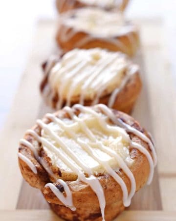 Cream Cheese Filled Cinnamon Roll Cups ~ fit refrigerated cinnamon rolls in a muffin pan, fill with sweetened cream cheese, bake until golden, and then drizzle with icing for a fun, easy, special breakfast treat! | FiveHeartHome.com
