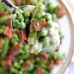 Creamy Spring Peas with Bacon + Mint ~ this ultimate Easter side dish features a delicious combo of flavors and textures from sweet green peas, fresh sugar snaps, salty bacon, a decadent cream sauce, and refreshing pops of mint | FiveHeartHome.com