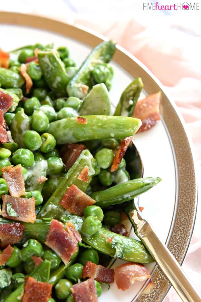 Close-up of spoon digging into Creamed Peas.