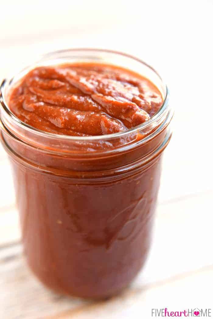 Jar of Homemade Enchilada Sauce on a table.