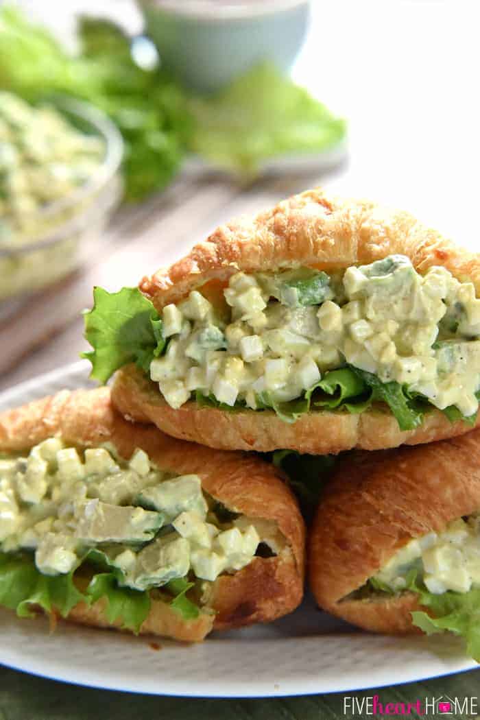 Avocado Egg Salad in croissants on serving platter.