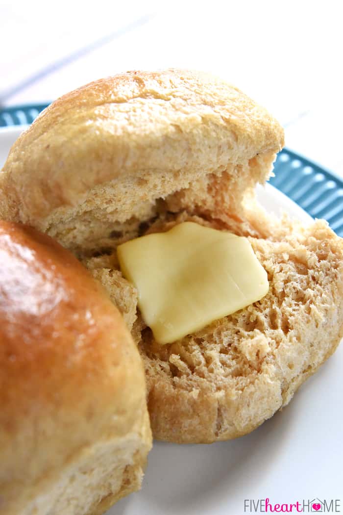 Butter melting inside a Whole Wheat Dinner Roll that's been sliced open.