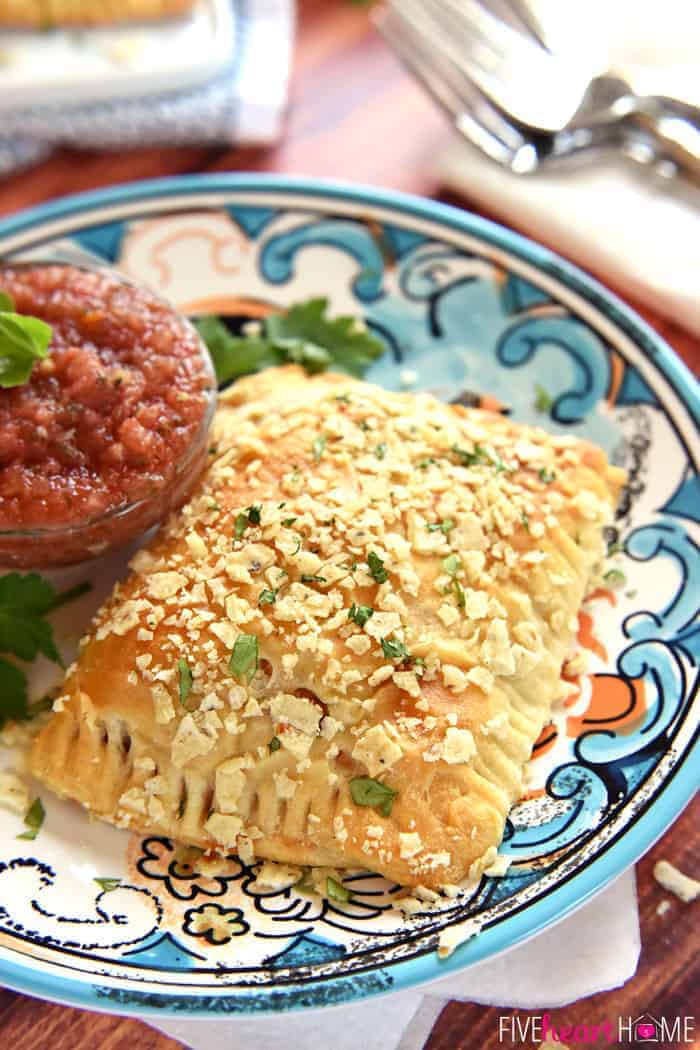 Creamy Chicken Taco Hand Pies ~ crescent roll dough filled with a savory mixture of diced chicken, cream cheese, taco seasoning, and fresh cilantro, and topped with a crunchy layer of crushed tortilla chips | FiveHeartHome.com Close-Up on Decorative Plate with a Side of Salsa for Dipping