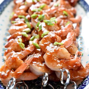 Honey-Ginger Shrimp Skewers with Asian Quinoa ~ effortless enough for a weeknight yet special enough for company, these tasty shrimp are glazed with a sweet and tangy homemade BBQ sauce and served atop a bed of flavorful quinoa infused with soy sauce, garlic, and fresh ginger | FiveHeartHome.com