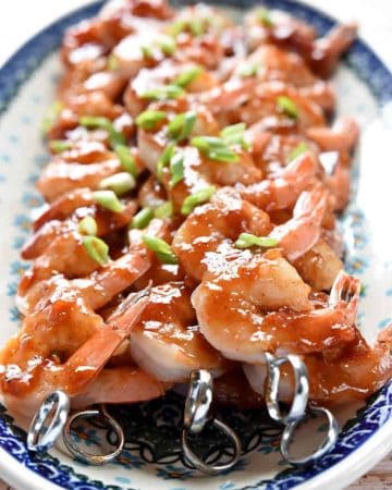 Honey-Ginger Shrimp Skewers with Asian Quinoa ~ effortless enough for a weeknight yet special enough for company, these tasty shrimp are glazed with a sweet and tangy homemade BBQ sauce and served atop a bed of flavorful quinoa infused with soy sauce, garlic, and fresh ginger | FiveHeartHome.com