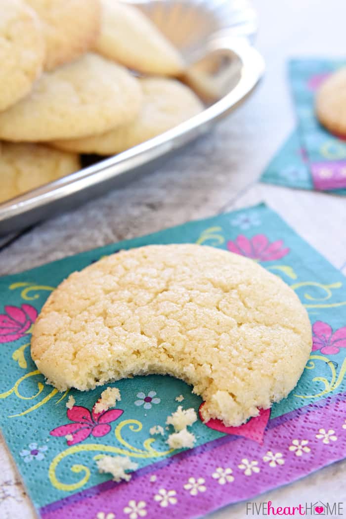 Soft Sugar Cookies ~ easy to make because they require NO ROLLING! They're tender and puffy with a crunchy coating of sugar and loads of vanilla flavor! | FiveHeartHome.com Close-up of a Soft Sugar Cookie with missing bite.