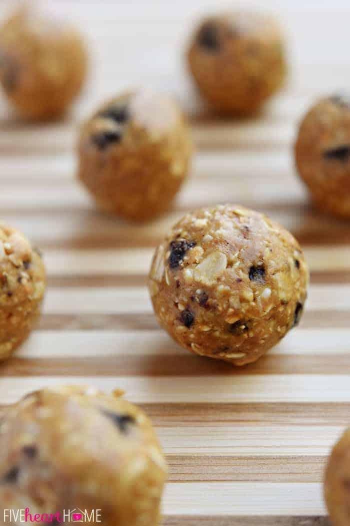 Oatmeal Energy Bites spaced out on a wooden cutting board.