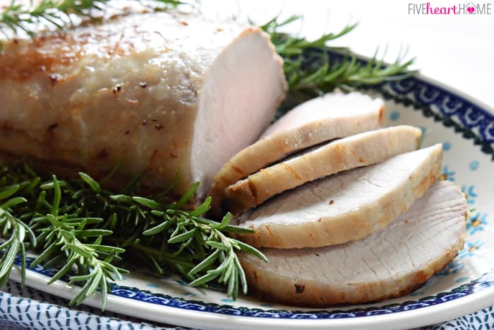 Rosemary Cider Brined Pork Loin sliced on decorative platter.