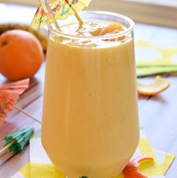 Sunshine Smoothie in glass with garnish.