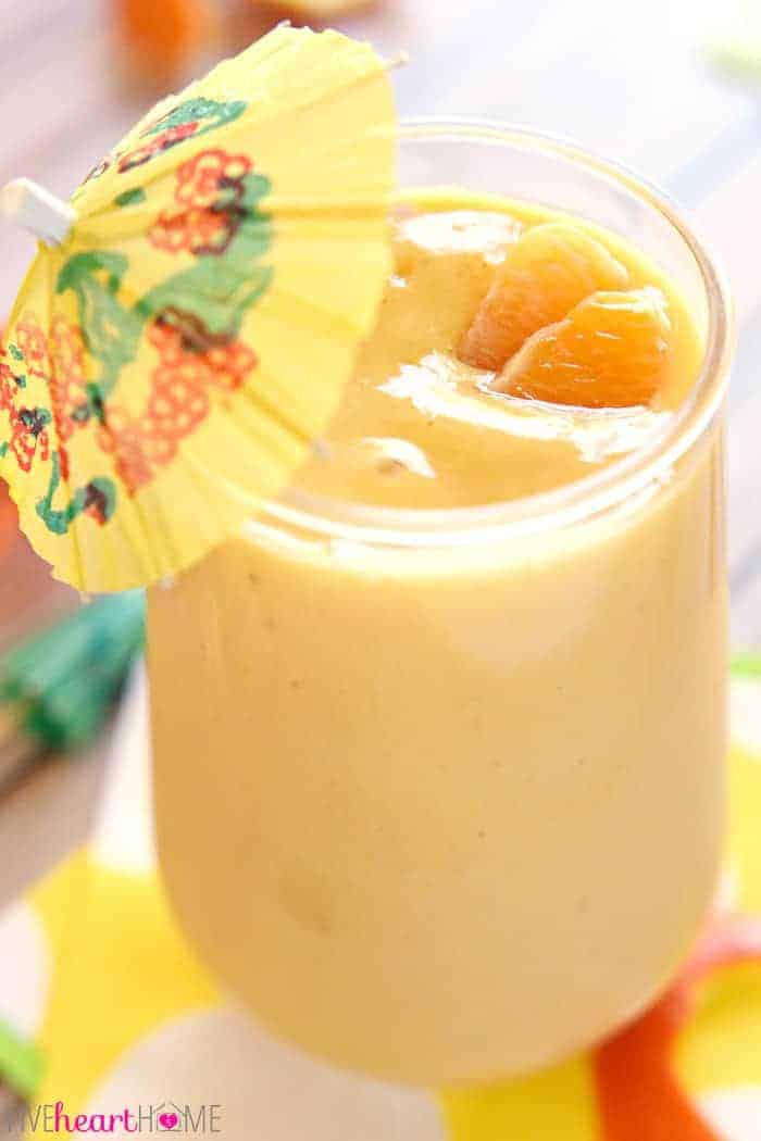 Close-up of Sunshine Smoothie with mini umbrella garnish.