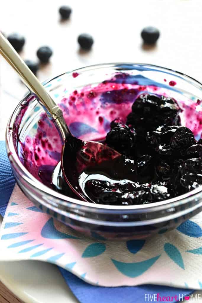 Blueberry Compote recipe in glass bowl with spoon.