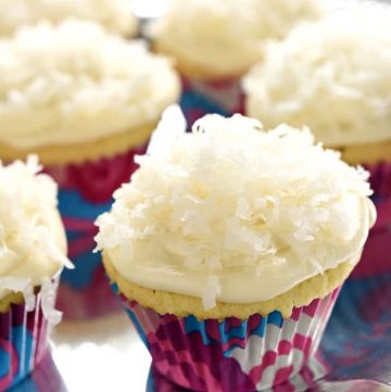 One-Bowl Coconut Cupcakes ~ these easy-to-make cupcakes are extremely moist (thanks to coconut milk) and topped with tangy cream cheese frosting and sweetened coconut flakes | FiveHeartHome.com