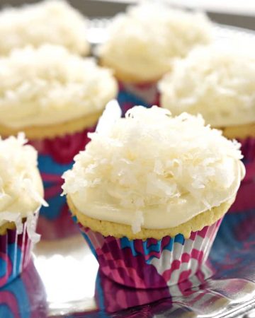 One-Bowl Coconut Cupcakes ~ these easy-to-make cupcakes are extremely moist (thanks to coconut milk) and topped with tangy cream cheese frosting and sweetened coconut flakes | FiveHeartHome.com