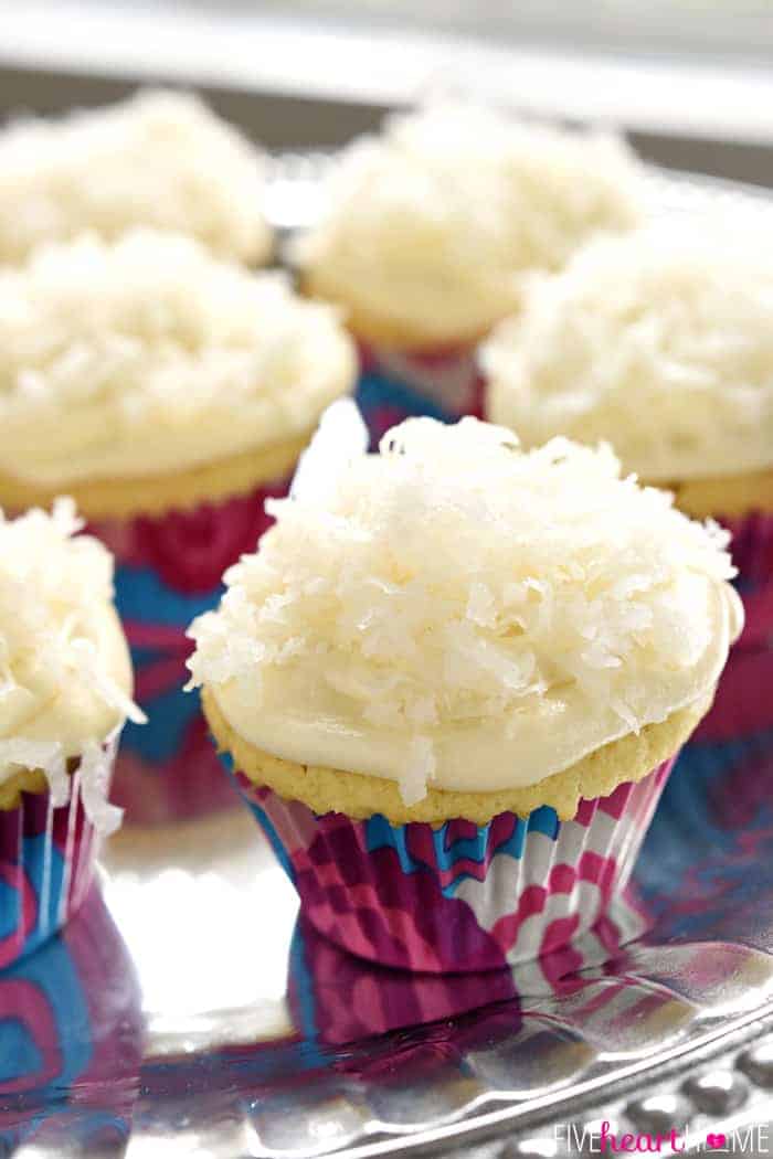 Coconut Cupcakes topped with cream cheese frosting and more coconut.