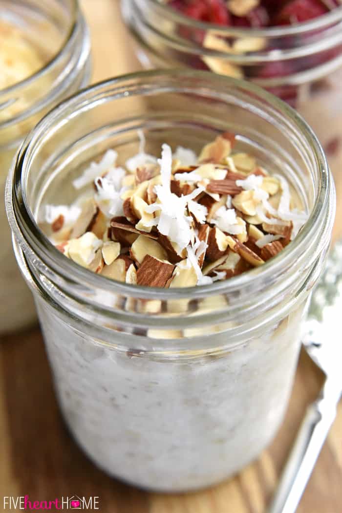 The ULTIMATE Guide to Overnight Oats ~ creamy, wholesome Overnight Oats are as simple as refrigerating oats, milk, yogurt, and your favorite flavors overnight for an instant, no-cook breakfast. And here are three yummy flavors to get you started...Peanut Butter Banana, Raspberry Nutella, & Coconut Almond! | FiveHeartHome.com Overnight Oats with coconut and almonds on top.