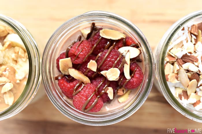 Aerial view of three Overnight Oats recipes lined up with different toppings.