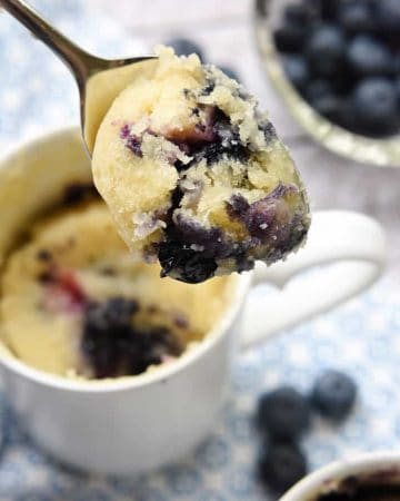 Spoonful of Blueberry Muffin Mug Cake scooped out of mug.