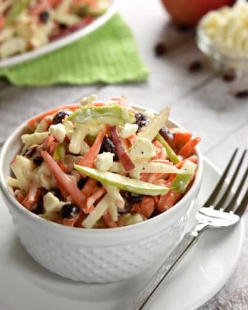Carrot Apple Slaw ~ with crunchy carrots, sweet and tart apples, dried cranberries, salty feta cheese, and a creamy dressing, this salad is a refreshingly sweet and savory side dish for summer! | FiveHeartHome.com