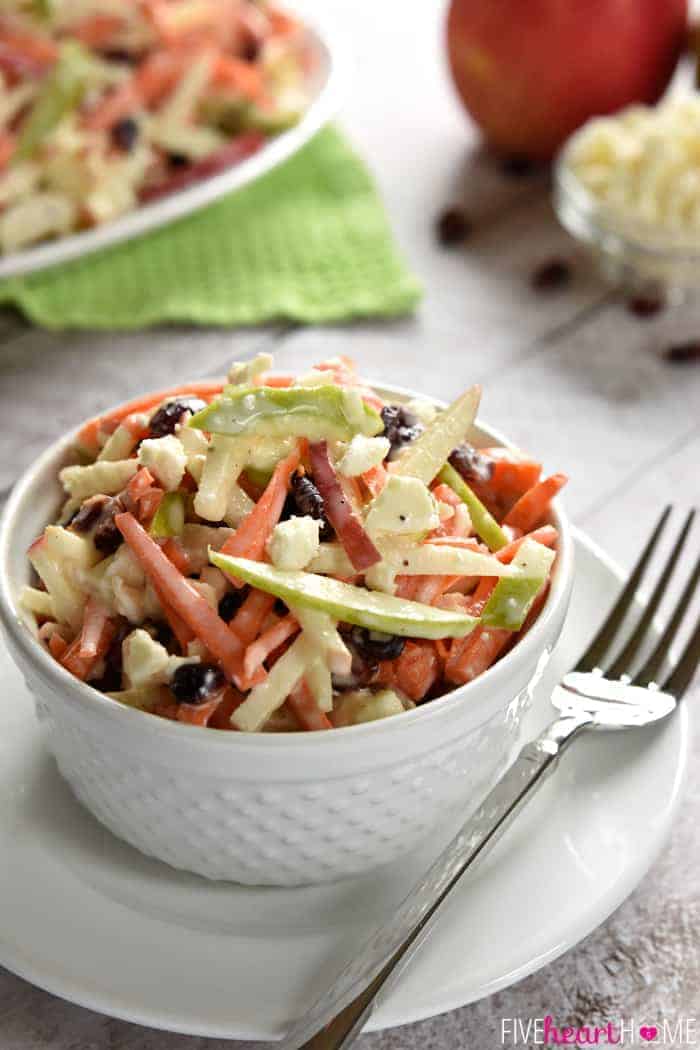 Bowl of Apple Slaw with carrots, dried cranberries, and feta.