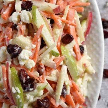 Carrot Apple Slaw ~ with crunchy carrots, sweet and tart apples, dried cranberries, salty feta cheese, and a creamy dressing, this salad is a refreshingly sweet and savory side dish for summer! | FiveHeartHome.com