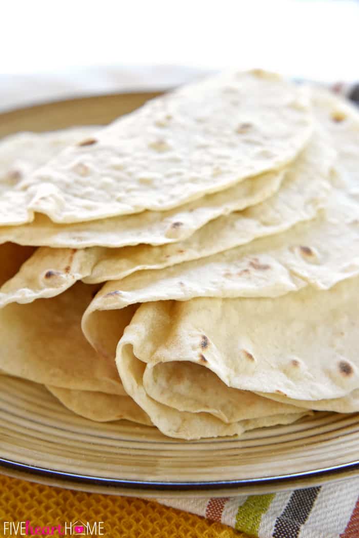 Homemade tortillas stacked and folded over.