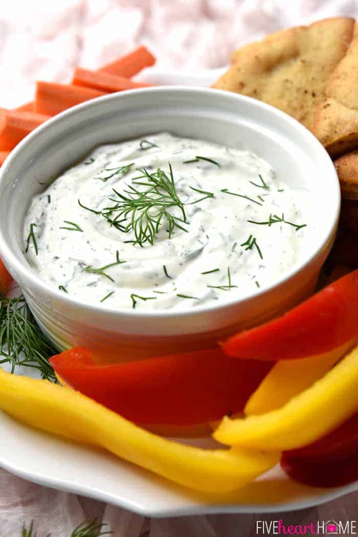 Bowl of Dill Dip with on platter with crudite and pita chips.