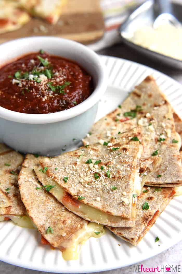 Pizza Quesadillas and blue bowl of dipping sauce on a white serving plate 