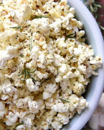 Rosemary Parmesan Popcorn ~ freshly-popped popcorn is drizzled with rosemary- and garlic-inflused olive oil and sprinkled with grated Parmesan, minced rosemary, garlic salt, and black pepper, making this recipe a flavorful snack for parties, munching, or movie watching! | FiveHeartHome.com
