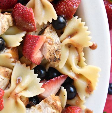 Chicken Berry Pasta Salad ~ a sweet and savory summer dish drizzled with fresh Strawberry Balsamic Vinaigrette...and with its red, white, and blue color scheme, it's the perfect recipe for 4th of July picnics, potlucks, and BBQs! | FIveHeartHome.com