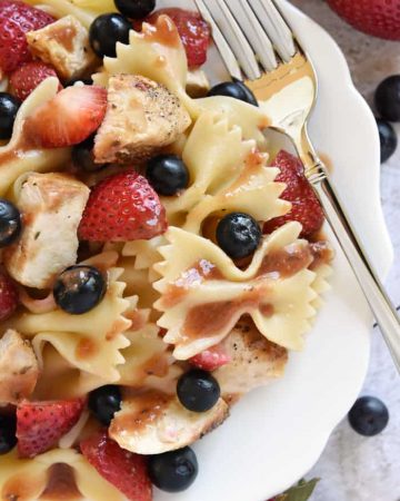 Chicken Berry Pasta Salad ~ a sweet and savory summer dish drizzled with fresh Strawberry Balsamic Vinaigrette...and with its red, white, and blue color scheme, it's the perfect recipe for 4th of July picnics, potlucks, and BBQs! | FIveHeartHome.com