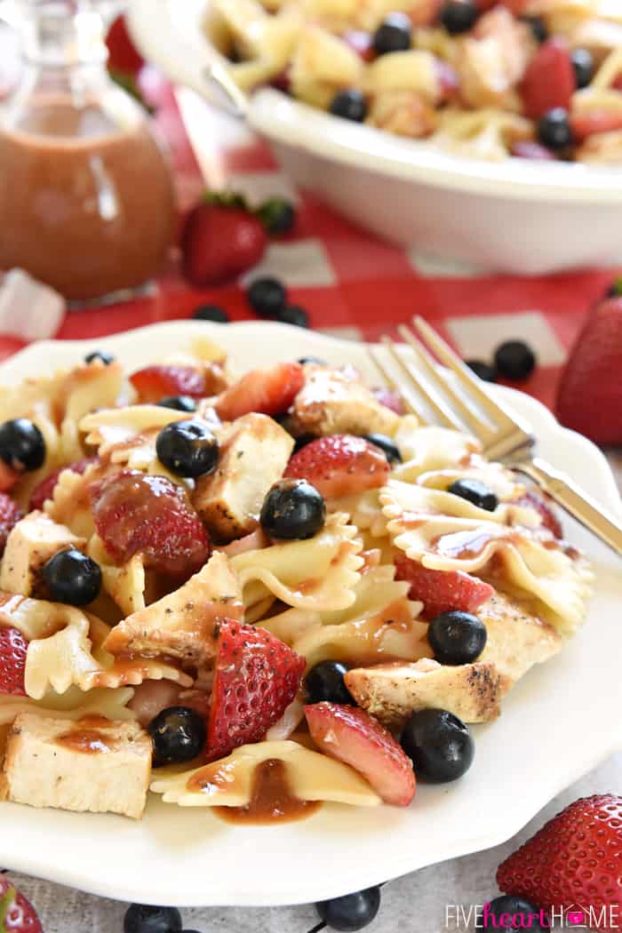 Chicken Berry Pasta Salad in white bowl on red checkered tablecloth