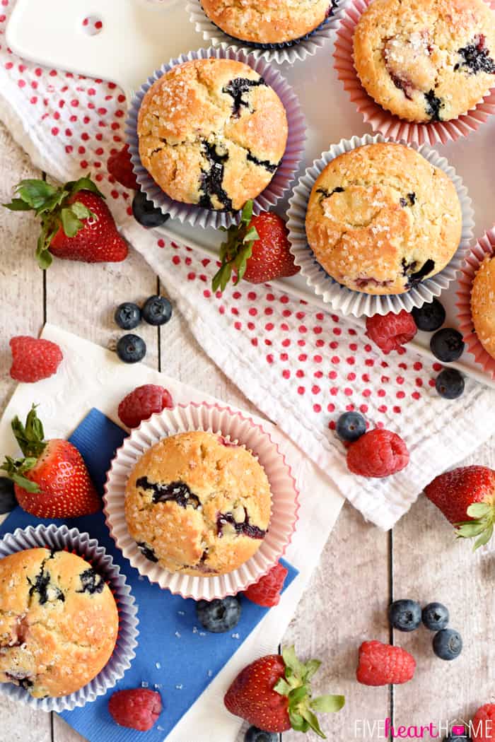 Aerial view of Mixed Berry Muffins on table with fresh berries.