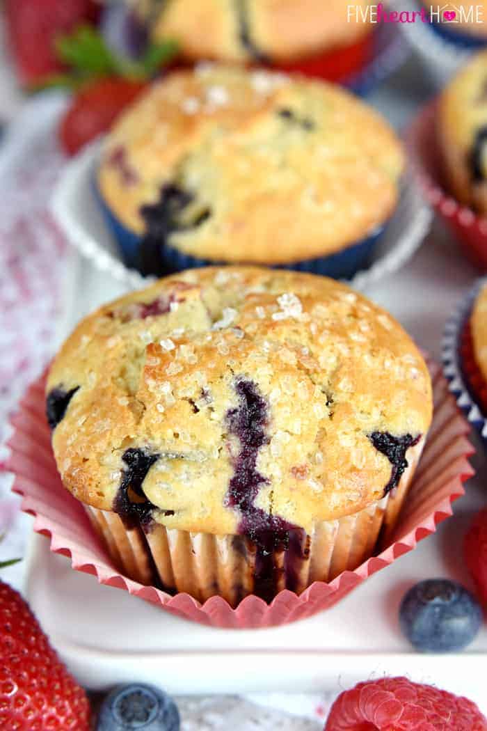 Mixed Berry Muffins on white platter with fresh fruit. 