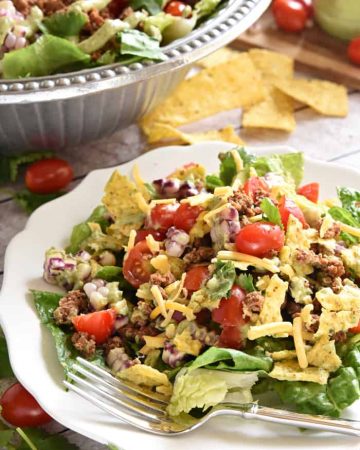 Ultimate Taco Salad ~ an explosion of contrasting flavors and textures, from spicy taco meat and velvety black beans to acidic tomatoes and crisp fresh corn, all topped with crunchy tortilla chips and a creamy, cilantro-flecked Avocado Ranch Dressing! | FiveHeartHome.com