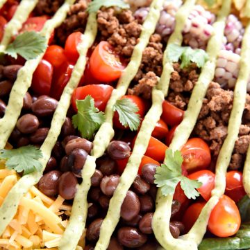 Ultimate Taco Salad ~ an explosion of contrasting flavors and textures, from spicy taco meat and velvety black beans to acidic tomatoes and crisp fresh corn, all topped with crunchy tortilla chips and a creamy, cilantro-flecked Avocado Ranch Dressing! | FiveHeartHome.com