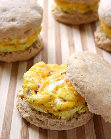 Easy Freezer Breakfast Sandwiches ~ cheesy scrambled eggs with ham are sandwiched inside of flaky biscuits in these make-ahead sandwiches, perfect for busy mornings and breakfast on-the-go! | FiveHeartHome.com
